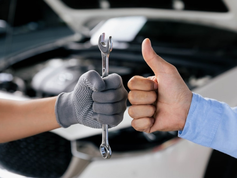 Mechanics,Is,Holding,A,Spanner,While,The,Other,Is,Showing